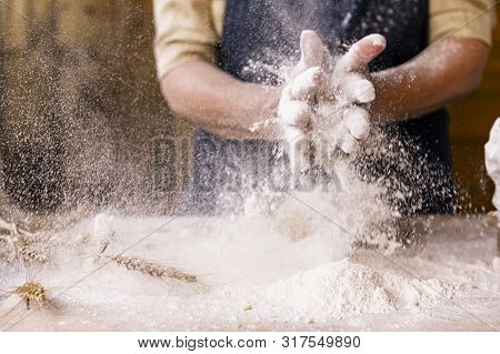 Womens Hands, Flour And Dough. Levitation In A Frame Of Dough And Flour. A Woman In An Apron Is Prep