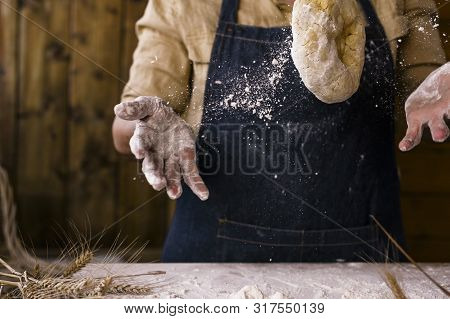 Womens Hands, Flour And Dough. Levitation In A Frame Of Dough And Flour. A Woman In An Apron Is Prep