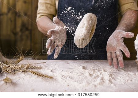 Womens Hands, Flour And Dough. Levitation In A Frame Of Dough And Flour. A Woman In An Apron Is Prep