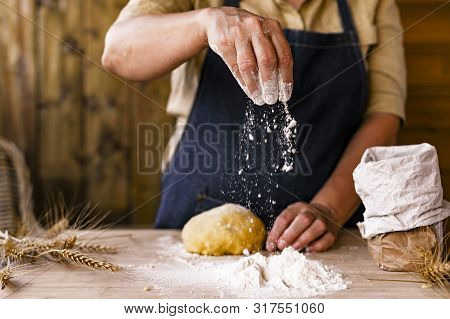 Womens Hands, Flour And Dough. Levitation In A Frame Of Dough And Flour. A Woman In An Apron Is Prep
