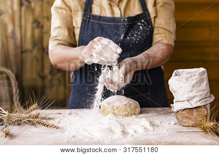 Womens Hands, Flour And Dough. Levitation In A Frame Of Dough And Flour. A Woman In An Apron Is Prep