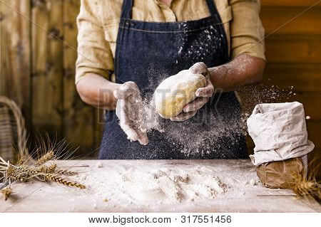 Womens Hands, Flour And Dough. Levitation In A Frame Of Dough And Flour. A Woman In An Apron Is Prep