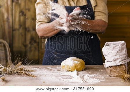 Womens Hands, Flour And Dough. Levitation In A Frame Of Dough And Flour. A Woman In An Apron Is Prep
