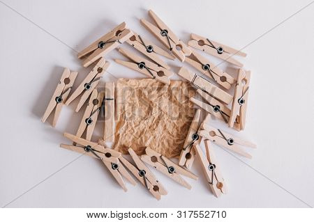 Woodenl Clothespins, Paper Clip And Brown Sticker On White Background. Isolated On White. View From 