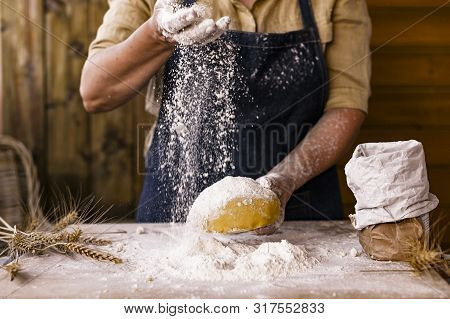 Womens Hands, Flour And Dough. Levitation In A Frame Of Dough And Flour. A Woman In An Apron Is Prep
