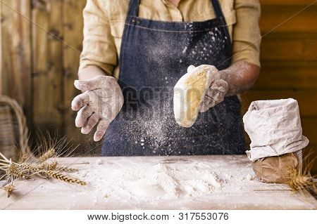 Womens Hands, Flour And Dough. Levitation In A Frame Of Dough And Flour. A Woman In An Apron Is Prep