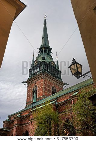 Sweden, Stockholm, On An Old Street In Gamlastan. The Ancient Part Of The City. The Bell Tower Of Th