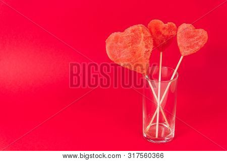 Decorative Ornaments Of Fruit Pulp - Hearts On A Wooden Stick In A Transparent Glass, Isolated On A 