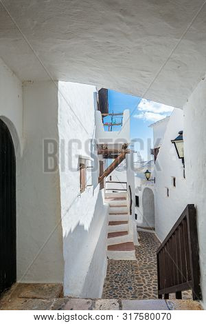 Narrow Street In The Traditional Fishing Village Of Binibeca On The Coast Of Menorca, Spain.
