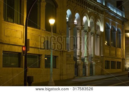 Night Photo With Warm Light, Streetlight And Several Collumns,