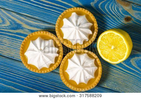 White Aircake With Lemon Filling And Lemon On A Wooden Table