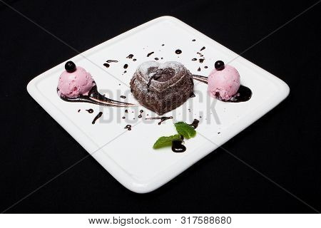 Dessert Fondan Chocolate With Ice-cream On A White Plate On A Black Background. Exquisite French Cho