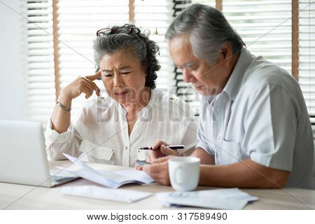 Serious Asian Senior Couple Thinking About Their Debts With Laptop Computer. Saving, Financials, Mon
