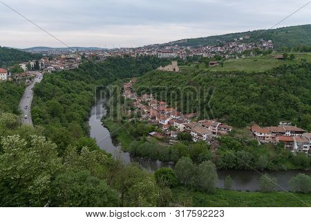 Panoramic View Of Veliko Tarnovo Old Town, Yantra River And View To Tower And Trapezitsa Fortress. B