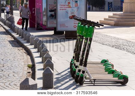 Bucharest, Romania - August 08, 2019: Several Lime-s Electric Scooters Are Parked On A Sidewalk In B