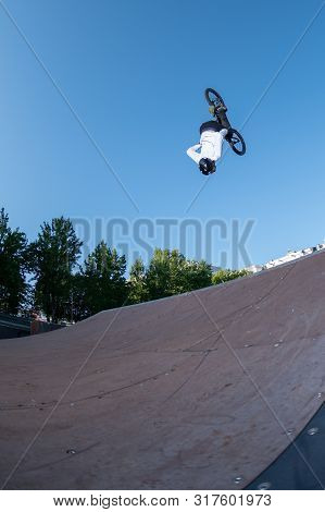 Biker Jump High From Jump Box Ramp Performing Dangerous Backflip Trick.