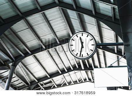 Large Clock On The Train Station. Railway Station Clock Hanging Onto The Roof.