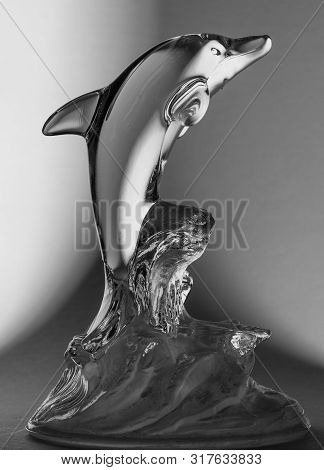 Dolphin Glass Staute Jumping Out Of The Water On A Bw Gradient Background
