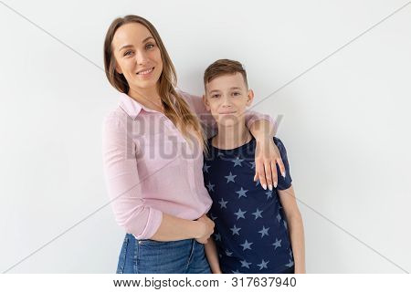 Good-looking Single-parent Mom And Teen Son On White Background. Cohesion, Friendship And Family Rel