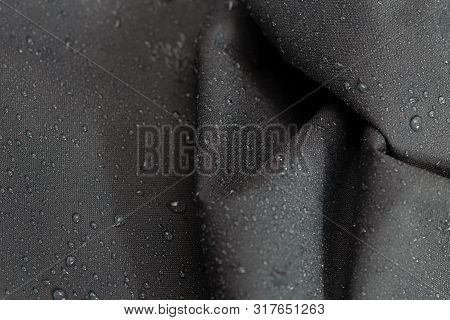 Dark Gray Waterproof Hydrophobic Crumpled Cloth Closeup With Rain Drops Selective Focus Background