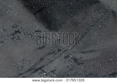 Dark Gray Waterproof Hydrophobic Cloth Closeup With Rain Drops Selective Focus Background
