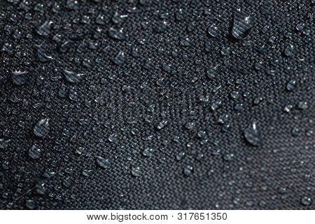 Dark Gray Waterproof Hydrophobic Cloth Closeup With Water Drops Selective Focus Background