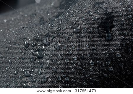 Dark Gray Waterproof Hydrophobic Cloth Closeup With Water Drops Selective Focus Background