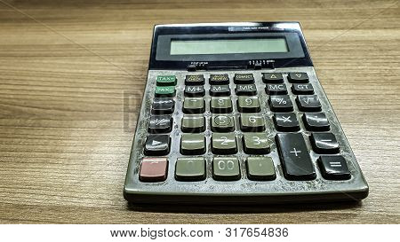Old Calculatator On Wooden Table, Vintage Tone Of Calculator On Wooden Background, Top View Of Calcu