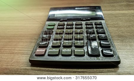 Old Calculatator On Wooden Table, Vintage Tone Of Calculator On Wooden Background, Top View Of Calcu
