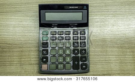 Old Calculatator On Wooden Table, Vintage Tone Of Calculator On Wooden Background, Top View Of Calcu