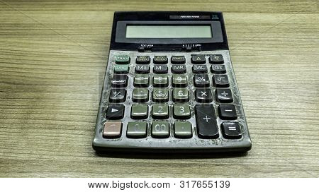 Old Calculatator On Wooden Table, Vintage Tone Of Calculator On Wooden Background, Top View Of Calcu
