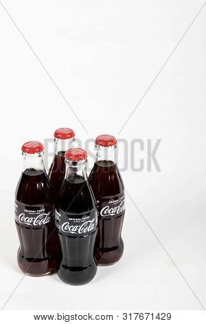London, United Kingdom, 16th August 2019:- A Pack Of 4 Coca-cola Glass Bottles. Contains 10.6g Of Su