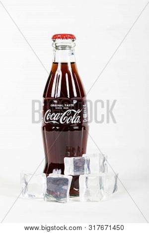 London, United Kingdom, 16th August 2019:- A Coca-cola Glass Bottle With Ice. Contains 10.6g Of Suga