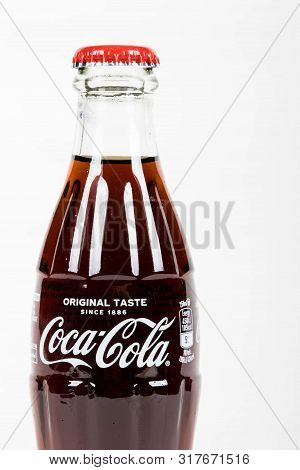 London, United Kingdom, 16th August 2019:- A Coca-cola Glass Bottle. Contains 10.6g Of Sugar Per 100