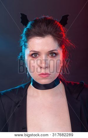 Halloween, Holidays And Carnival Concept - Vamp Woman In Jacket And With Bat Ears In Gothic Style.