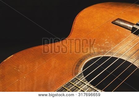 Shapes And Lines Of An Old Acoustic Guitar, The Body Curves, Sound Hole, Frets And Old Rusty Nylon S