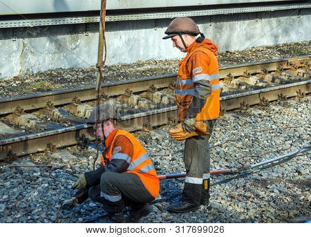 Murmansk, Russia - April 22, 2019: Railway Workers Connect Ground Wire