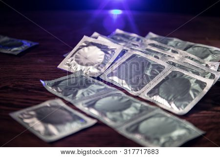 Close Up Of A Young Beautiful Girl Holding An Open Female Condom, Safe Sex Concept. Protection Again