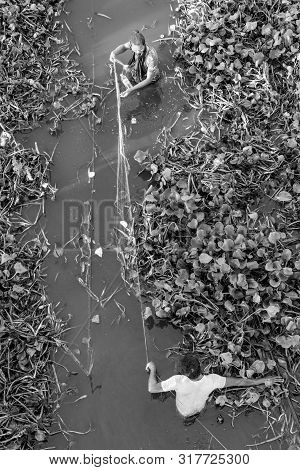 Mandalay, Myanmar - 03 December, 2018: Black And White Picture Of Local Burmese Fishermen Fishing Wi