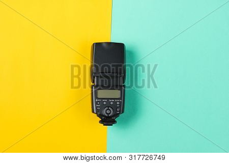 Camera Flash On Colored Paper Background. Top View
