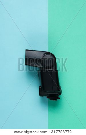 Camera Flash On Colored Paper Background. Top View