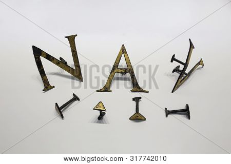 Malaga, Spain - Sept 21th, 2018: Roman Set Of Letters And Punctuation Marks Made Of Gilded Bronze At