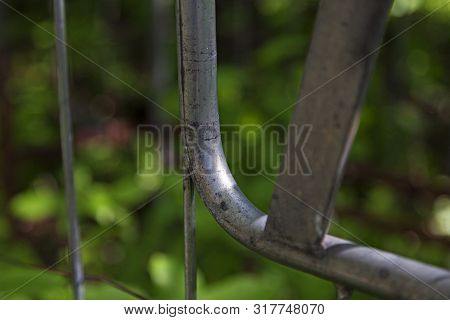 Part Of Metal Fence At Grubbe In Umea With Greenery In The Background