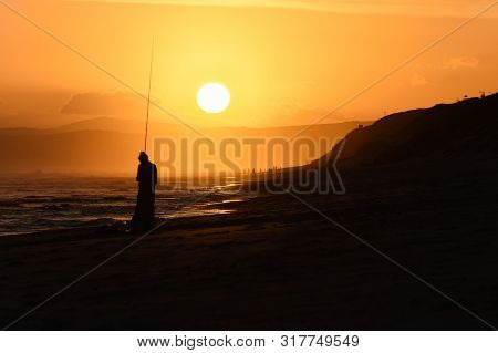 Fishing Rod Girl Silhouette On Sunset Beach, Mossel Bay, South Africa