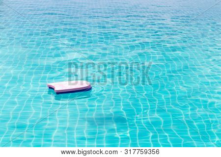 Swimming Foam Pad Are Floating In The Large Swimming Pool.