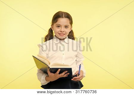 Child Girl School Uniform Clothes Hold Book And Pen. Girl Cute Write Down Idea Notes. Notes To Remem