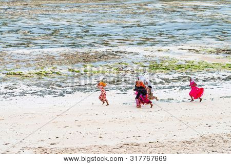 Stown Town, Tanzania - 11 January 2015: Local Girls Walk On Coast In Zanzibar