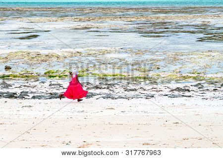 Stown Town, Tanzania - 11 January 2015: Local Girl Runs On Coast In Zanzibar