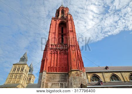 The Clock Towers Of Basilica Of Saint Servatius And Sint Janskerk Church, Located At Vrijthof, Maast