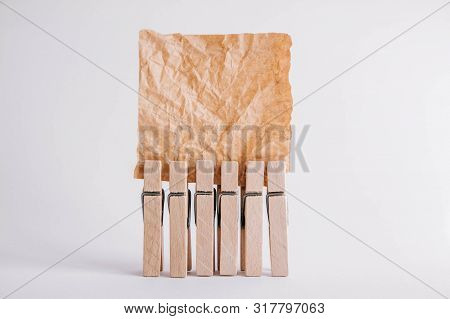 Woodenl Clothespins, Paper Clip And Brown Sticker On White Background. Isolated On White. Place For 